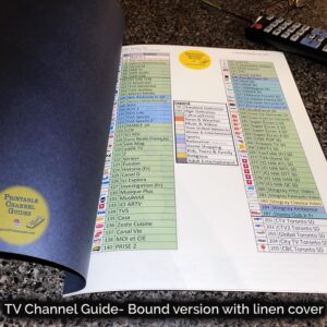 Colour-coded, printed channel guide bound with attractive blue linen covers. First page of guide seen. Caption reads, “TV Channel Guide - bound version (linen cover)”